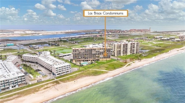 drone / aerial view featuring a beach view and a water view