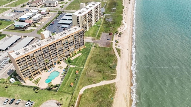 drone / aerial view with a water view and a beach view