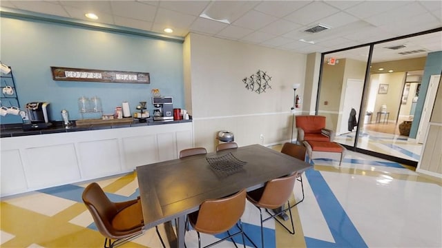 bar featuring white cabinets and a drop ceiling