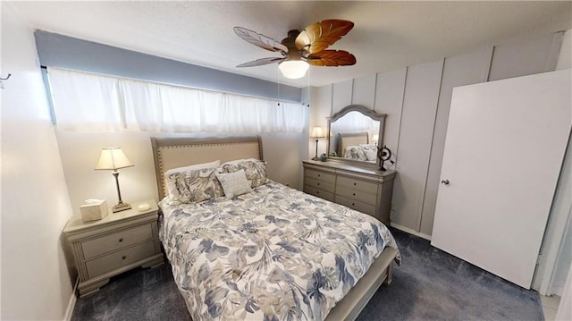 bedroom with ceiling fan and dark carpet