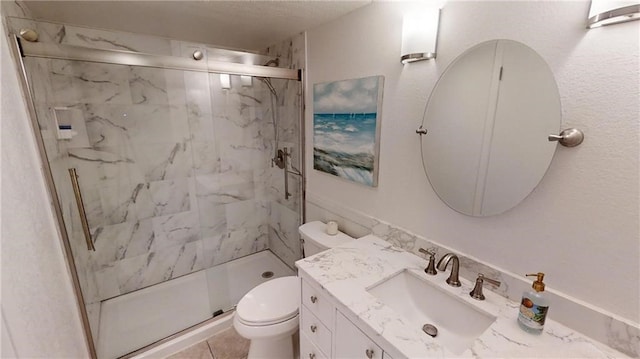 bathroom featuring an enclosed shower, vanity, and toilet