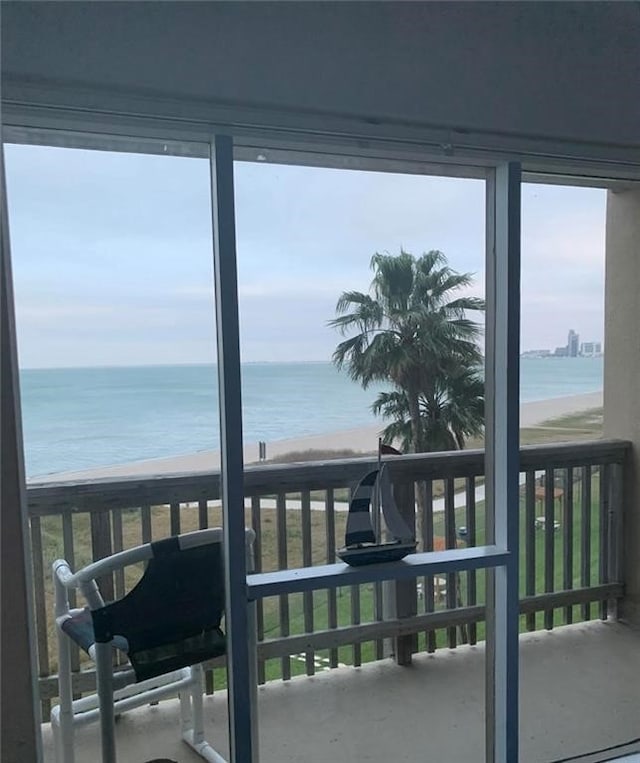 balcony with a beach view and a water view