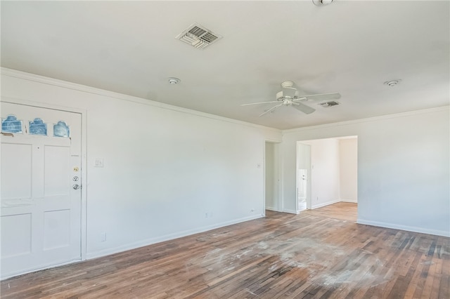 spare room with ornamental molding, wood-type flooring, and ceiling fan