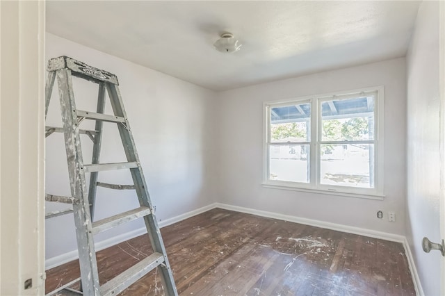 spare room with dark hardwood / wood-style flooring