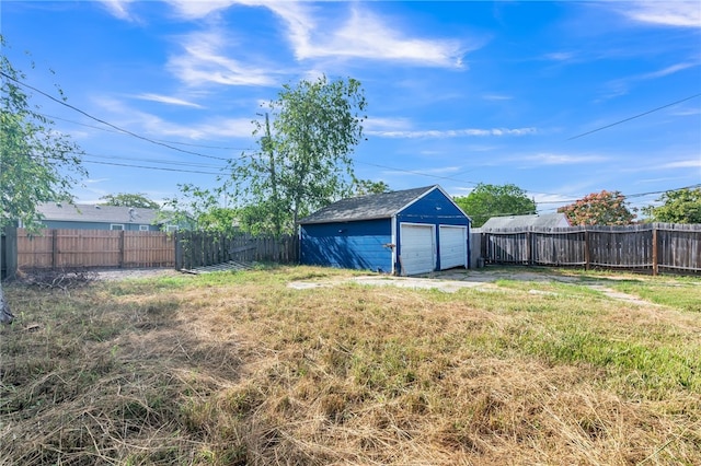 view of yard featuring a garage and an outdoor structure