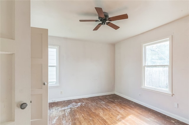 unfurnished room with light wood-type flooring, ceiling fan, and a healthy amount of sunlight