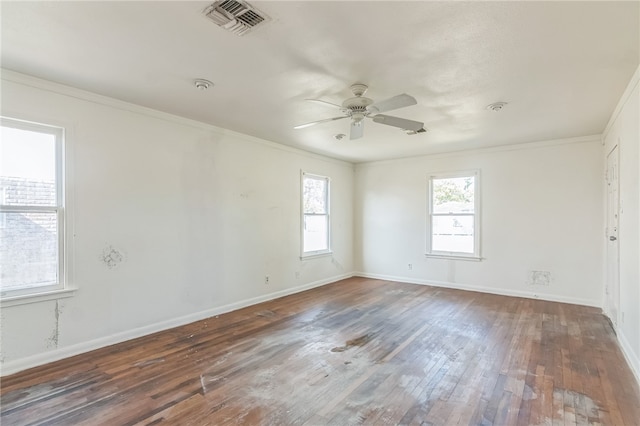 empty room with ceiling fan, dark hardwood / wood-style floors, and crown molding