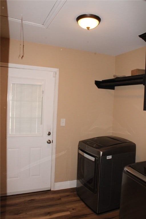 clothes washing area with dark wood-type flooring and washer and dryer