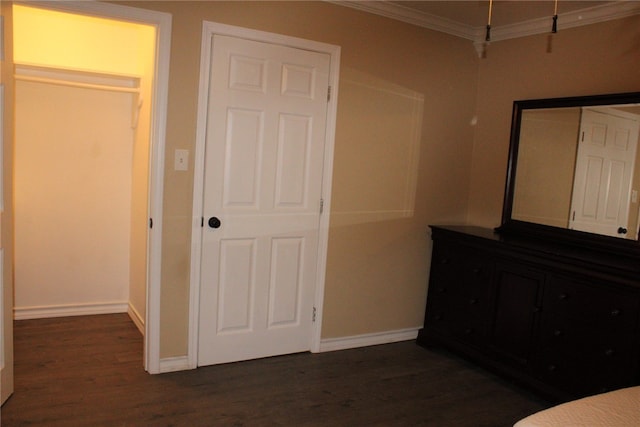 unfurnished bedroom with dark wood-type flooring and ornamental molding