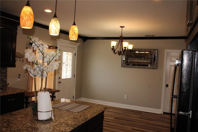 kitchen with crown molding, pendant lighting, and dark hardwood / wood-style flooring