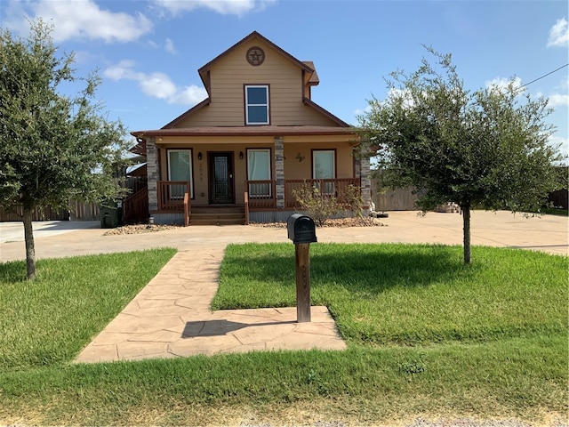 view of front of property with a porch and a front lawn