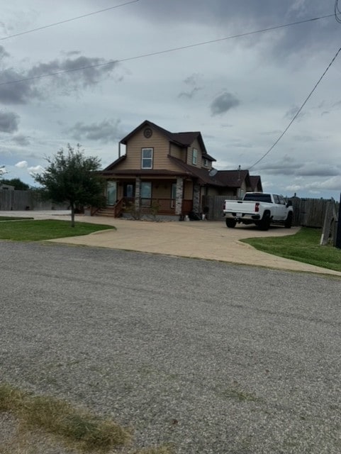 bungalow-style home with a porch and a front lawn