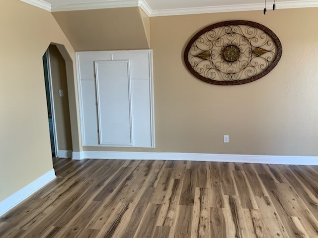 interior space featuring dark hardwood / wood-style flooring and ornamental molding