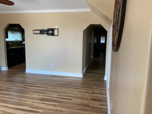 hallway featuring ornamental molding, sink, and dark hardwood / wood-style flooring