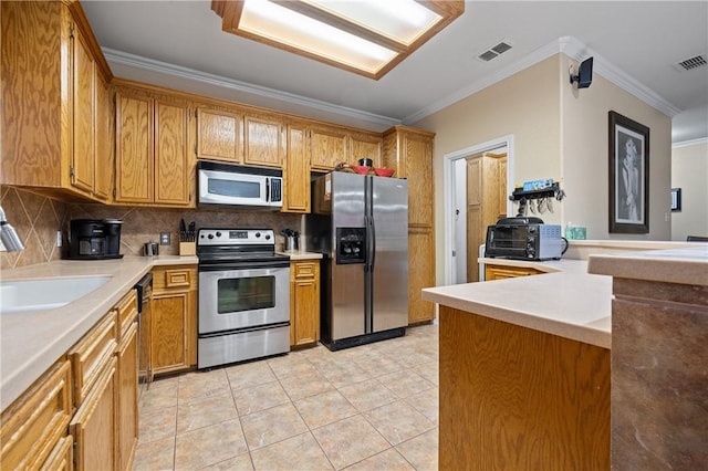 2401 Handlin Dr, Corpus Christi, TX 78418 - kitchen featuring decorative backsplash, visible vents, appliances with stainless steel finishes, a sink, and ornamental molding