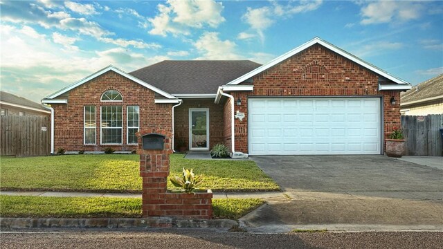2401 Handlin Dr, Corpus Christi, TX 78418 - ranch-style house featuring fence, brick siding, a garage, a front yard, and driveway