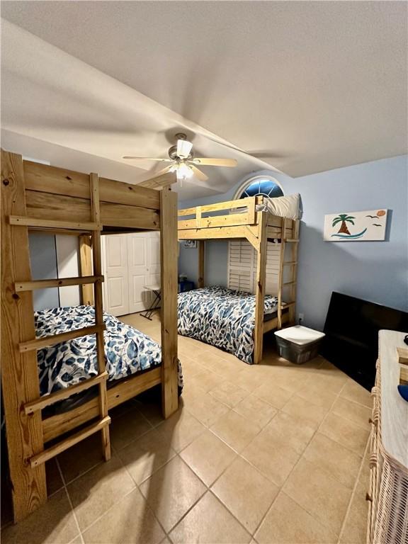 bedroom featuring light tile patterned floors and ceiling fan