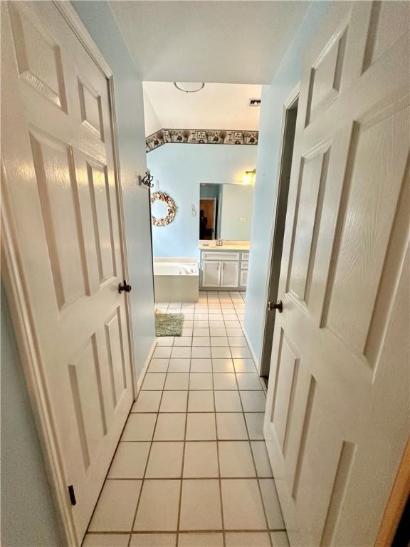 hall with light tile patterned flooring