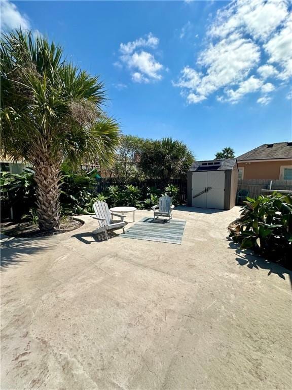 exterior space with a storage shed, an outdoor structure, and fence