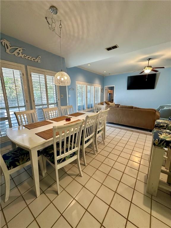 dining area featuring light tile patterned flooring, visible vents, and ceiling fan