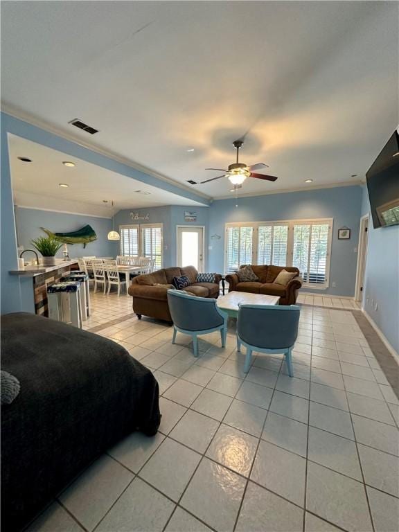 living area featuring light tile patterned floors, baseboards, and a wealth of natural light