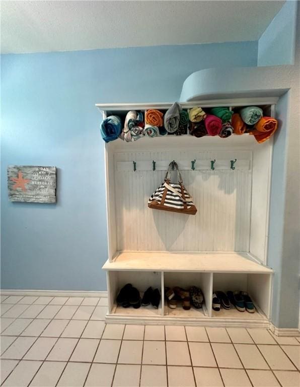 mudroom featuring tile patterned floors and baseboards