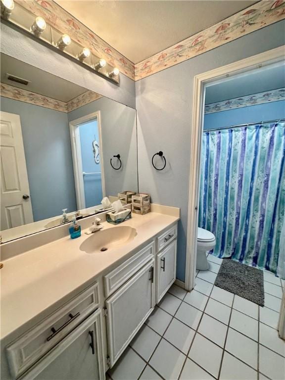 bathroom with tile patterned flooring, visible vents, curtained shower, toilet, and vanity