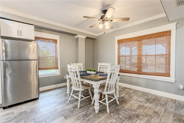 356 E Sagebrush St, Rockport, TX 78382 - dining space with baseboards, light wood finished floors, ceiling fan, and crown molding