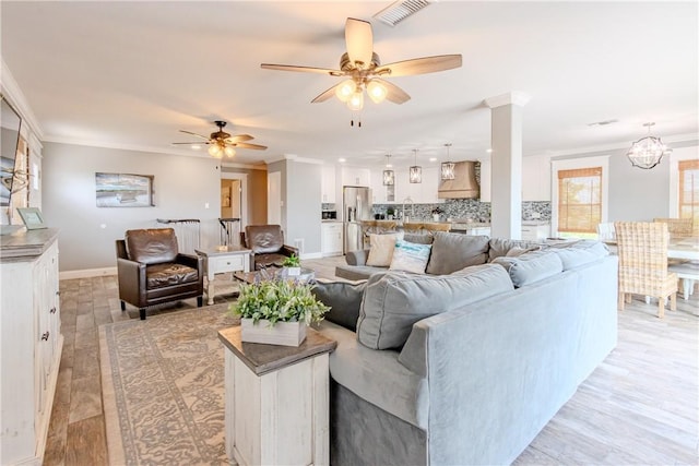 356 E Sagebrush St, Rockport, TX 78382 - living area with crown molding, a ceiling fan, baseboards, and a chandelier