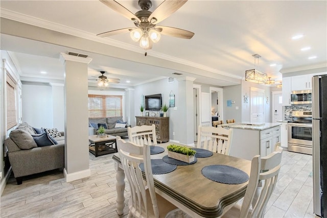 356 E Sagebrush St, Rockport, TX 78382 - dining space featuring ceiling fan, light wood-style flooring, baseboards, ornamental molding, and ornate columns