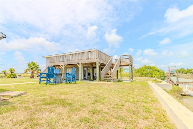 356 E Sagebrush St, Rockport, TX 78382 - rear view of house featuring a wooden deck, stairway, and a yard