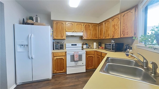 3014 Quail Spgs # D5, Corpus Christi, TX 78414 - kitchen with dark wood finished floors, under cabinet range hood, light countertops, a sink, and white appliances