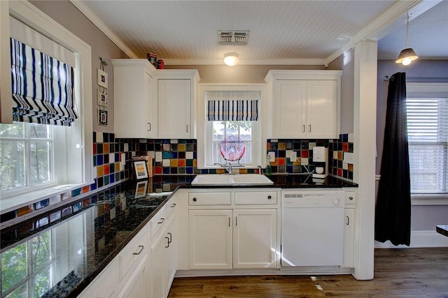 kitchen featuring visible vents, white dishwasher, a sink, and white cabinetry