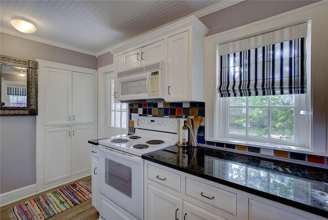 kitchen with white appliances, crown molding, white cabinets, and decorative backsplash