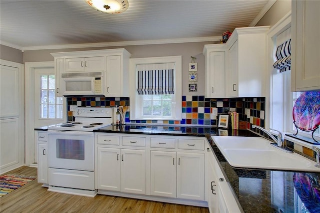 kitchen with white appliances, white cabinetry, ornamental molding, and a sink