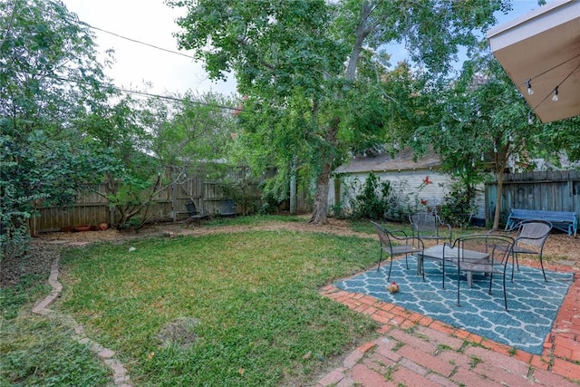 view of yard featuring a patio and a fenced backyard