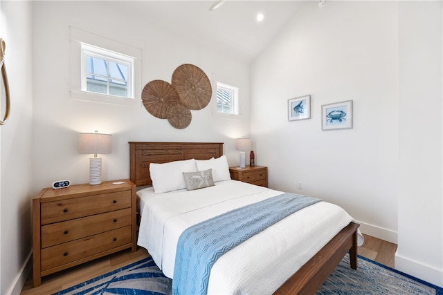 bedroom featuring wood-type flooring and vaulted ceiling