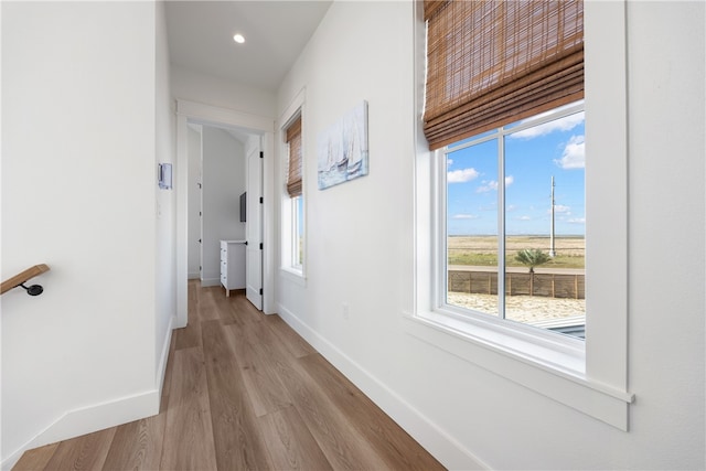 hallway with light hardwood / wood-style flooring