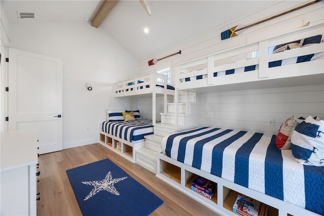 bedroom with light hardwood / wood-style flooring and lofted ceiling with beams