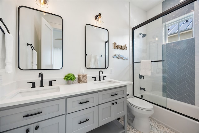 full bathroom with vanity, enclosed tub / shower combo, and toilet