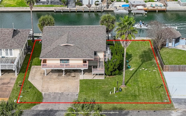 birds eye view of property with a water view