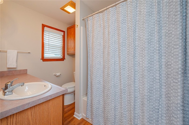 bathroom featuring wood-type flooring, vanity, and toilet