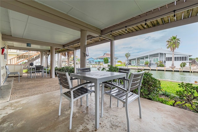 view of patio with a water view