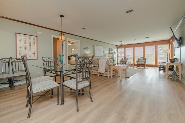 dining area featuring light hardwood / wood-style floors, ceiling fan, and crown molding