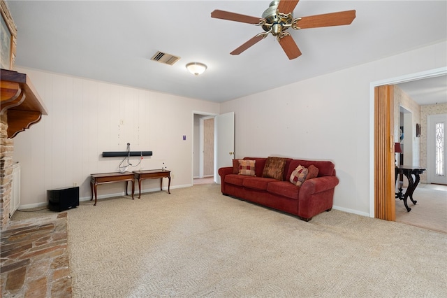 carpeted living room with ceiling fan