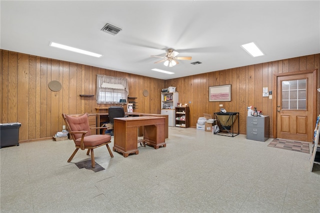 office with wood walls and ceiling fan