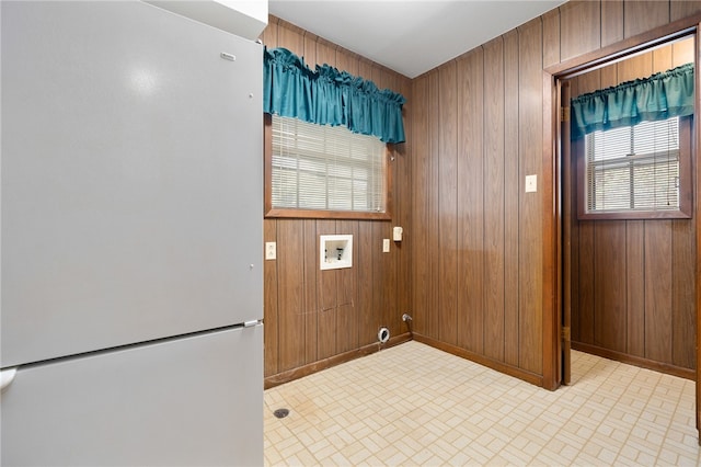 clothes washing area with wood walls and washer hookup