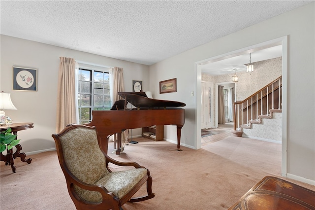 miscellaneous room with a textured ceiling and light colored carpet