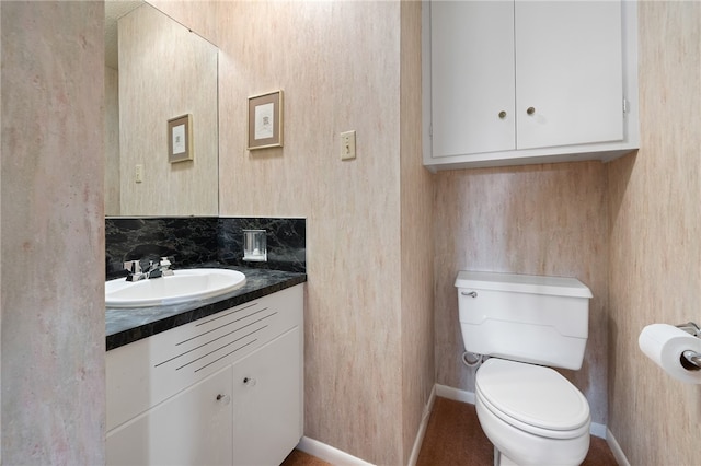 bathroom featuring decorative backsplash, vanity, and toilet