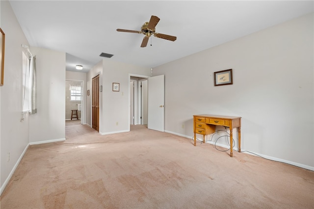 spare room with light carpet and ceiling fan